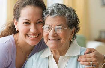 girl-grandma Younger woman giving her grandma a hug.