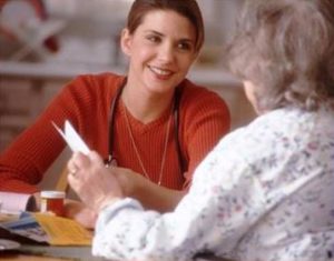 Health care plan facilitator helping woman