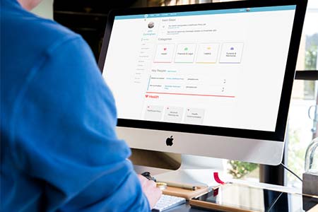 man sitting at a computer using cake website