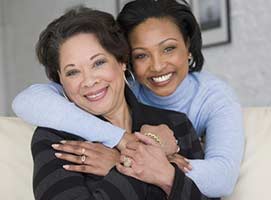 Black daughter and mom hugging